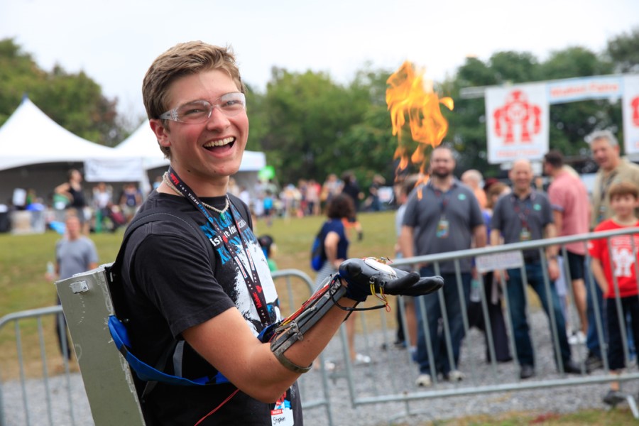 A young guy is showing his innovative invention at Maker Fest in Canada